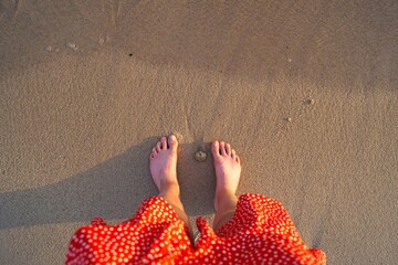 feet of a girl on the seashore