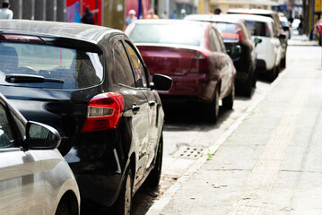 View of cars parked in a row on a street in the city of Salvador in Bahia.