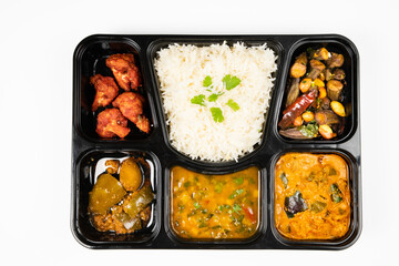 Indian Thali served with rice, fried shrimp, mushrooms and spices Menu Item on white background,, top down view