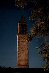 Old brick tower standing tall in the night 