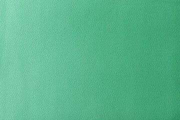 Texture of genuine leather, artificial leatherette green background