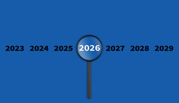Lens, magnifying glass focusing on the year 2026 on a Blue background. Financial or stock market strategies and past and future events.