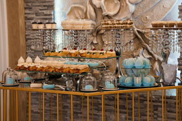 Elegant Dessert Table Display at Luxury Event: Pastries, Cakes, Macarons, Chandeliers, Gold...