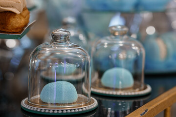 Pastel Macarons Display in Glass Cloches. Blue Confectionery, Bakery Interior, Vintage Style,...
