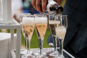 Champagne Pouring Ceremony. Sparkling Wine Toast at Elegant Outdoor Wedding Celebration with...