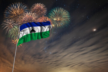 Waving National flag of Lesotho and holiday fireworks