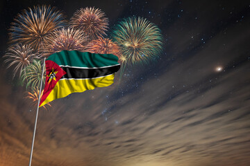 Waving National flag of Mozambique and holiday fireworks