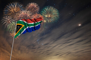 Waving National flag of South Africa and holiday fireworks