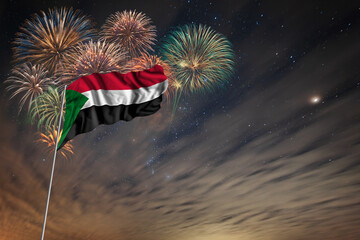 Waving National flag of Sudan and holiday fireworks
