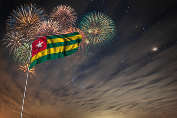 Waving National flag of Togo and holiday fireworks