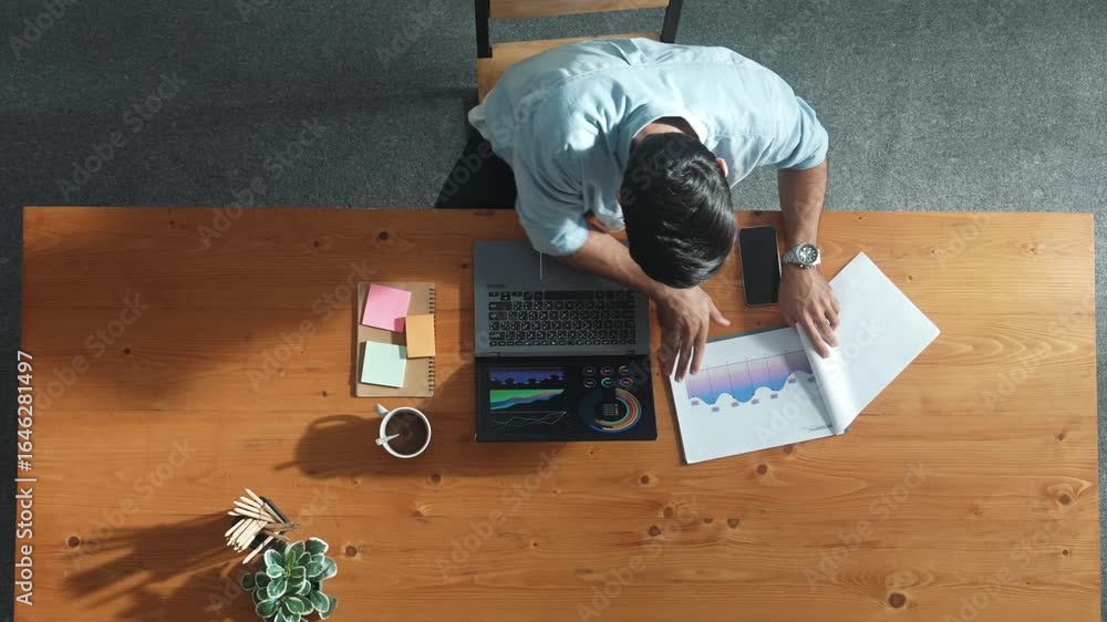 Poster top aerial view of manager working on laptop while looking at data analysis. leader compare financia