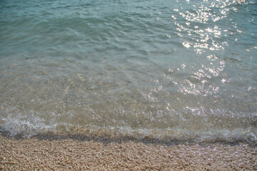 Adriatic sea surf water wave on pebble beach in Croatia