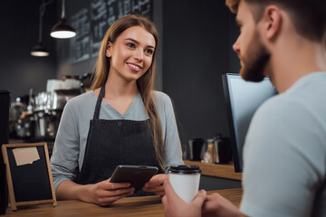 Customer service experience at a cafe with friendly barista serving drinks