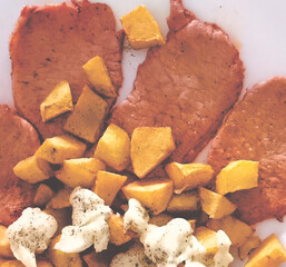 Marinated loin with potatoes. Zenith view and close up.