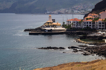 Lighthouse in Quinta Grande village, coastal resort architecture in Madeira and ocean view. Island