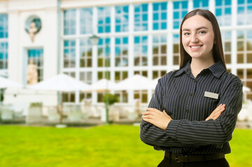 Young hostess near hotel outdoors. Space for text