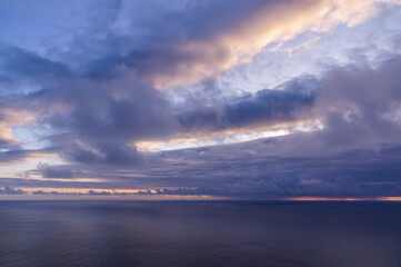 Serene seascape at sunset with layered clouds, at Ponta do Pargo