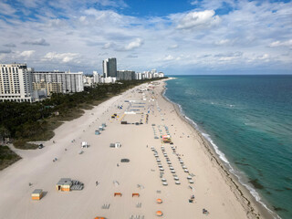 Sea relax under beach umbrella. Travel to sea. Aerial top view of sand beach with turquoise water....