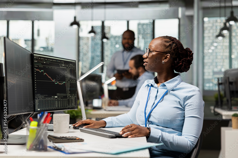 Aufkleber trader in brokerage firm office analyzing market metrics and executing trades using trading app pane