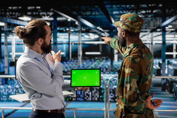 Military personnel overseeing AI computing operations on isolated screen in high tech server...