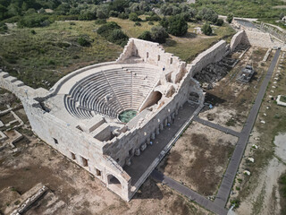 Restored bouleuterion of patara in Antalya province, semicircular marble seating, arched portico and orchestra, warm afternoon light, lycian heritage landmark, travel highlight near Kas on the coast