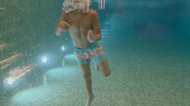 boy jump in a pool - hotel concept