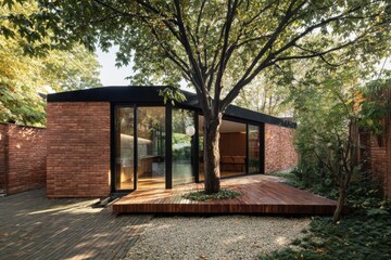 Contemporary architecture features a unique brick house with large windows surrounded by greenery in a tranquil garden setting during daylight hours