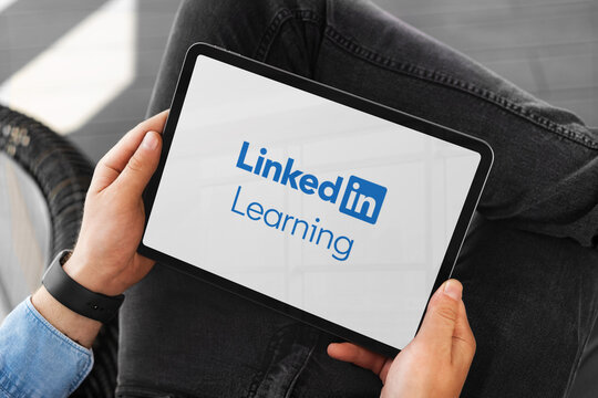Businessman using linkedin learning platform on tablet for professional development