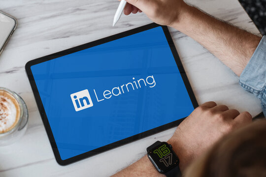 Businessman using linkedin learning platform on tablet for professional development