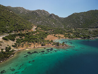 Turquoise cove with shallow reefs edges a grove of olives and low hills in Mugla Turkey Quiet rural...