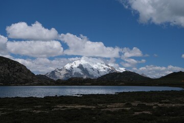 Snow-capped mountain reflected in a serene lake.
