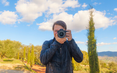 A photographer taking a picture of himself in the mirror
