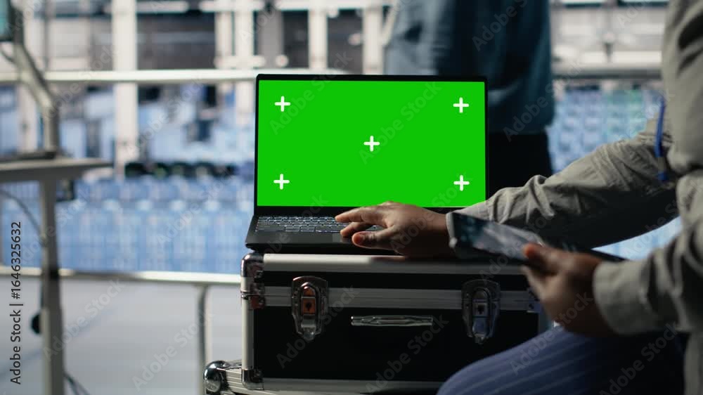 Poster it coworkers monitors server farm activity using isolated screen laptop. data center engineers revie