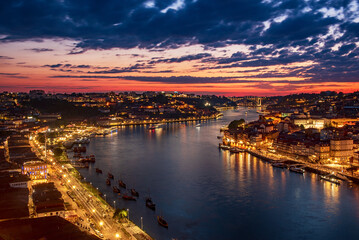 Scenic view of Porto city during sunset with a bridge over the river in Portugal.
