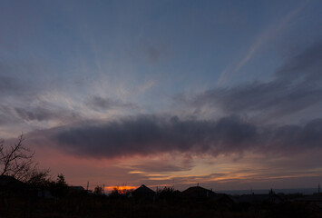 Landscape at sunset. Tragic gloomy sky. Panorama. Crimson twilight.