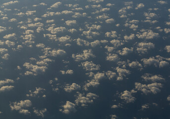Stratosphere, view of water through clouds. Seascape, view from above, from an airplane window.
