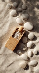 A minimalist flatlay featuring a rectangular wooden container holding a glass vial filled with small white objects, surrounded by smooth
