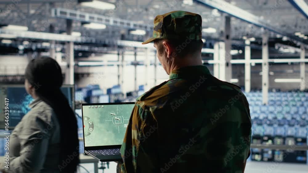 Poster military technician in data center tracking satellite coordinates using notebook software interface.
