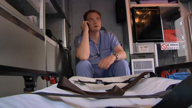 EMT Talking on Phone Inside Ambulance