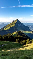 Fototapeta premium Mountain peak vista, lush valley