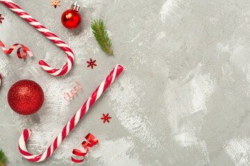 Christmas composition with lollipops on concrete background, top view