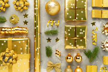 Handmade wrapped christmas gift boxes with stuff on concrete background, top view