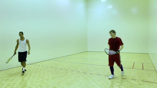 Two Athletes Playing Racquetball Inside Gym Court