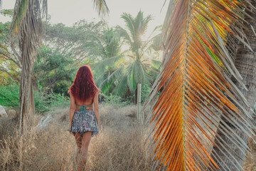 young woman walking in a tropical park
