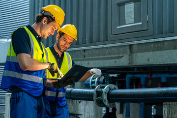Industrial engineer teamwork maintenance pipeline valves air HVAC cooling systems at construction...