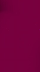 Solid deep crimson background.