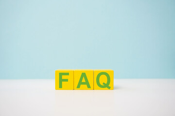 Yellow cubes spelling FAQ against a clear blue background