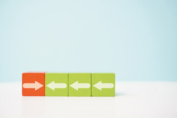 Four blocks displaying arrows showing contrasting directions with vibrant colors. Conflict, management, business, economy, diversity and direction concepts