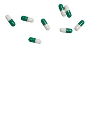 Green and white medication capsules