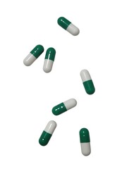 Green and white medication capsules